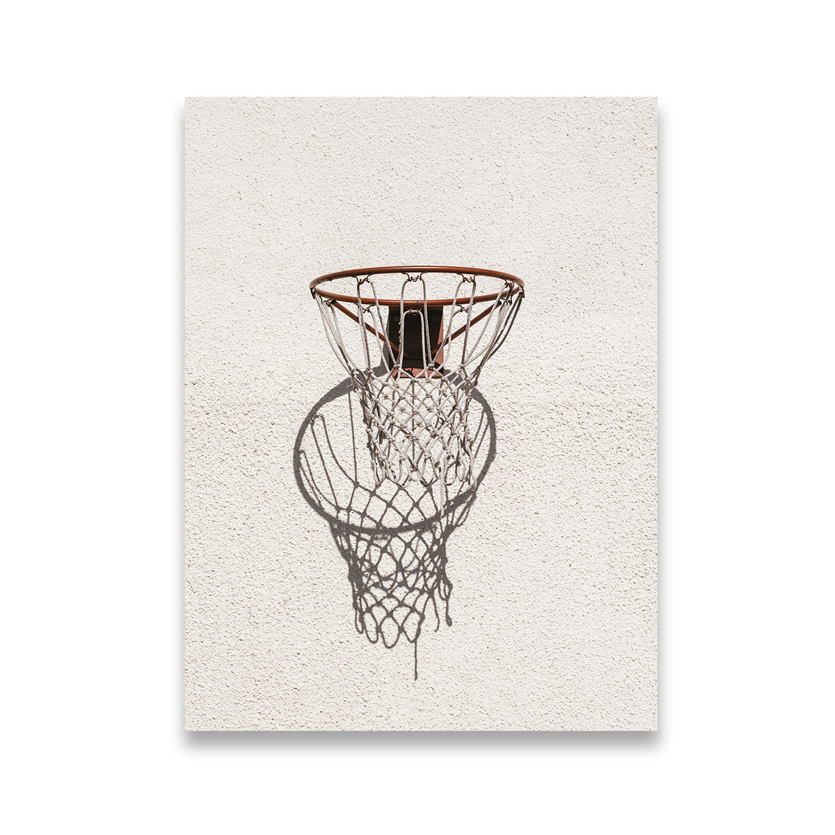 Outdoor basketball hoop and chain net casting a dramatic shadow on a textured stucco wall — canvas wall art