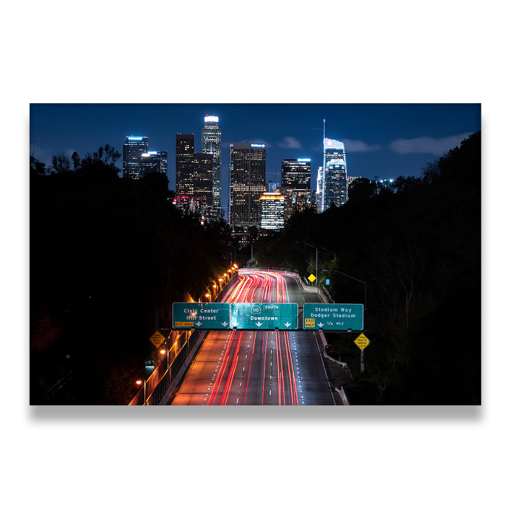 Downtown Los Angeles night freeway canvas wall art with long-exposure light trails and illuminated skyline
