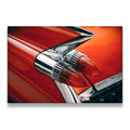 Close-up of a red 1950s classic car tail fin with chrome bullet taillights — retro American automotive canvas wall art