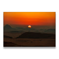 Desert sunset canvas wall art with silhouetted rock formations and fiery orange sky at dusk