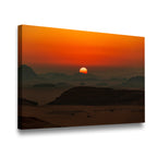 Gallery-wrapped desert landscape canvas wall art showing glowing amber sun setting over misty desert ridgelines