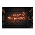 You Are What You Listen To amber neon sign on brick wall canvas wall art — music quote decor