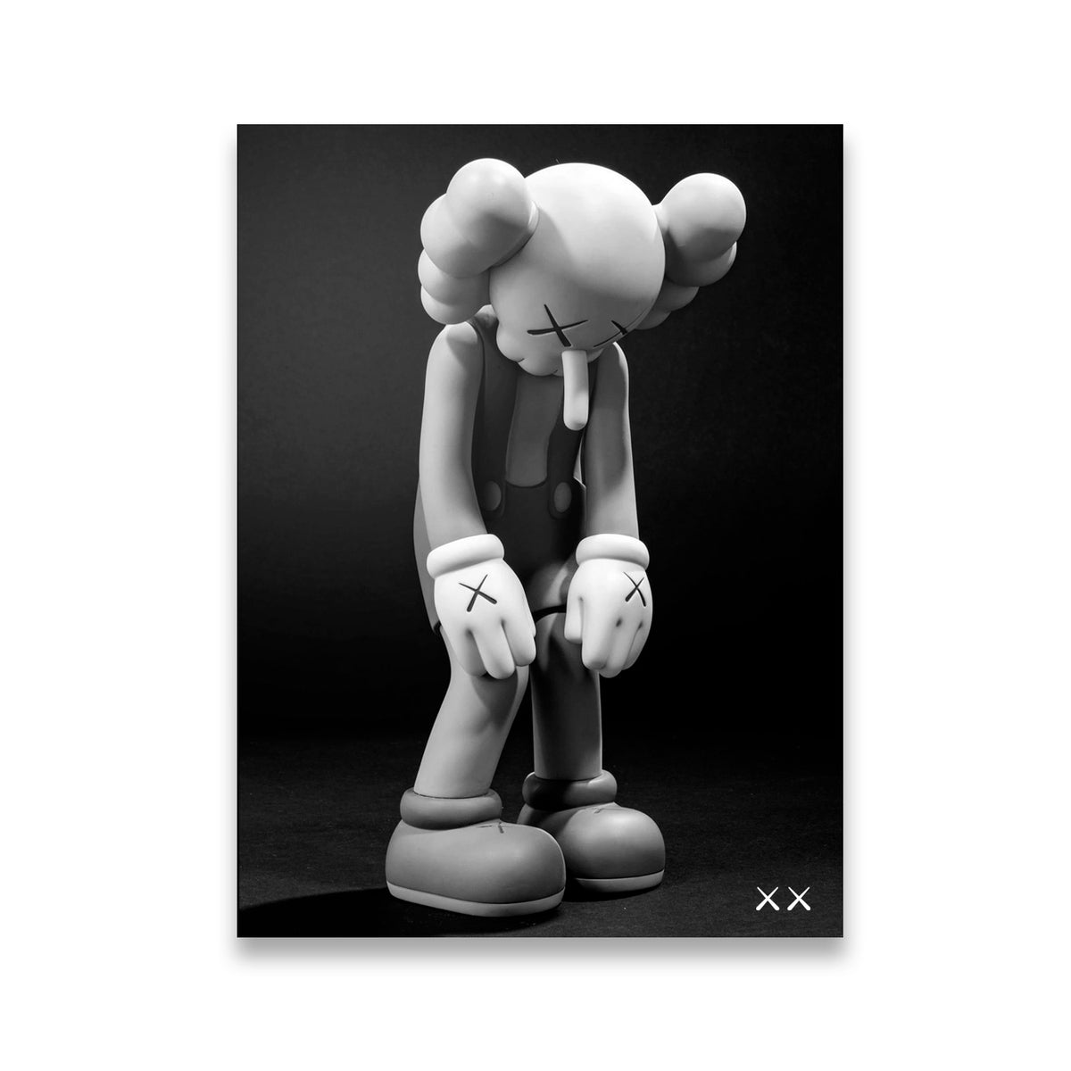 KAWS Companion figure bowed head black and white canvas wall art against dark backdrop
