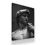 Gallery-wrapped black and white David sculpture canvas wall art with dark moody background side view