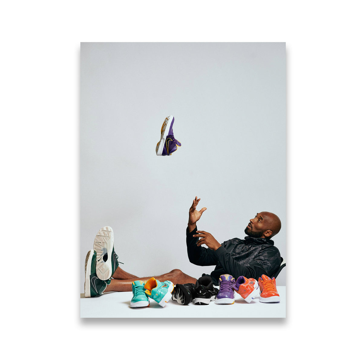 Kobe Bryant lounging with Nike Kobe sneaker collection canvas wall art, purple gold and multicolor colorways
