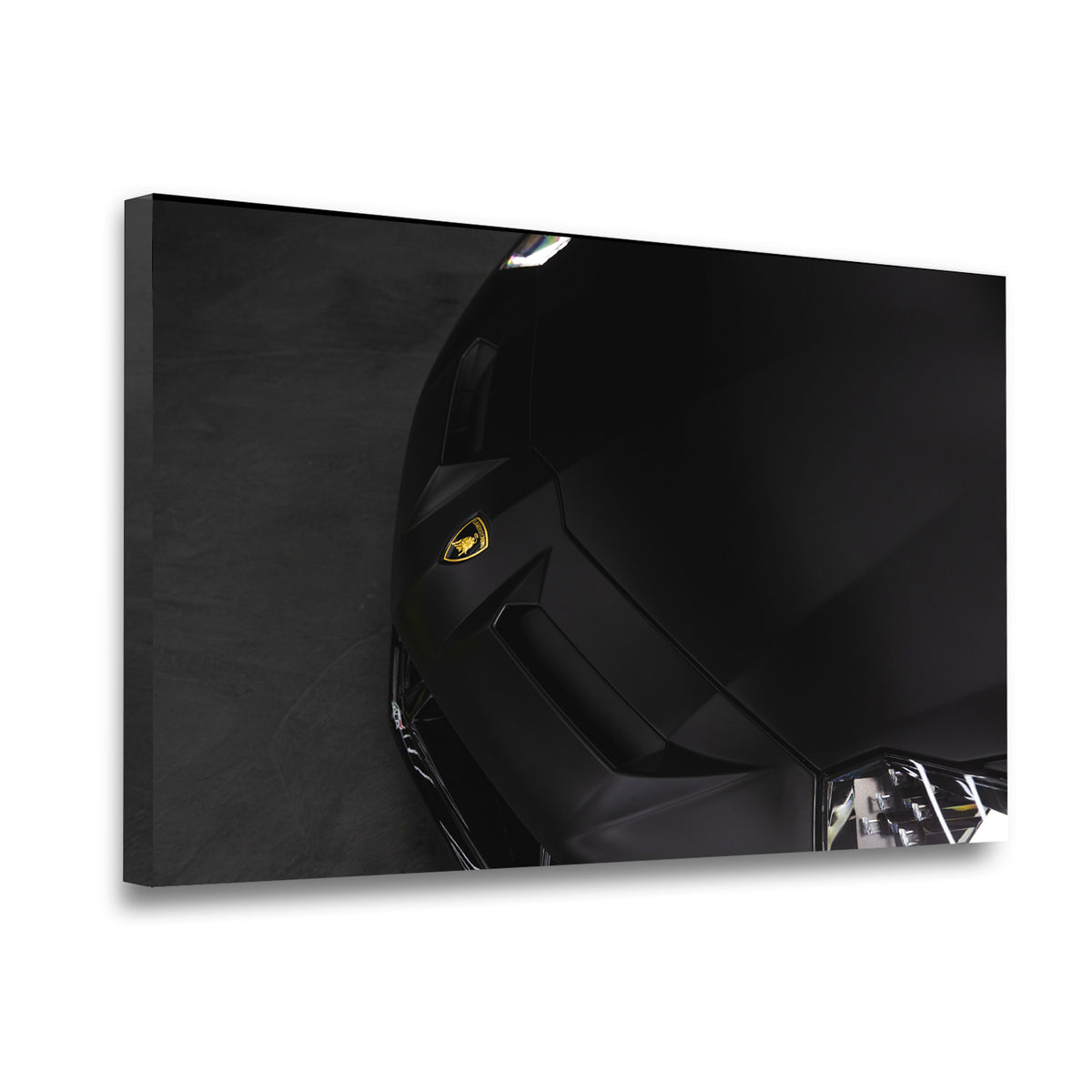 Gallery-wrapped canvas of a black Lamborghini supercar close-up with gold bull emblem, deep contrast archival print